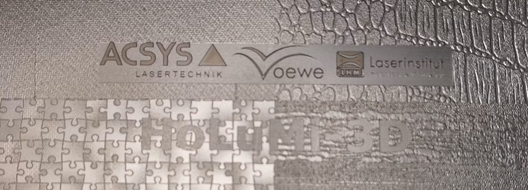 Metal plate featuring various patterns and the logos of the project partners