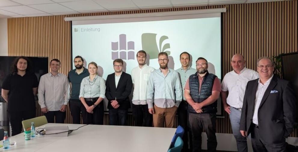 Gruppenbild vor einer Präsentationswand